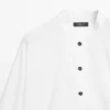 Camisa de cuello alto con botones dorados