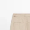 Pantalones de talle alto y corte holgado Pantalones de talle alto y corte holgado