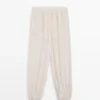Pantalones sarouel fluidos con detalle plisado Pantalones sarouel fluidos con detalle plisado