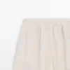 Pantalones sarouel fluidos con detalle plisado Pantalones sarouel fluidos con detalle plisado