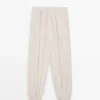 Pantalones sarouel fluidos con detalle plisado Pantalones sarouel fluidos con detalle plisado