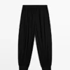 Pantalones sarouel semitransparentes con detalles de botones Pantalones sarouel semitransparentes con detalles de botones