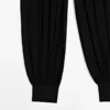 Pantalones sarouel semitransparentes con detalles de botones Pantalones sarouel semitransparentes con detalles de botones